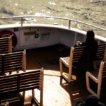 Woman on a boat deck with empty seats